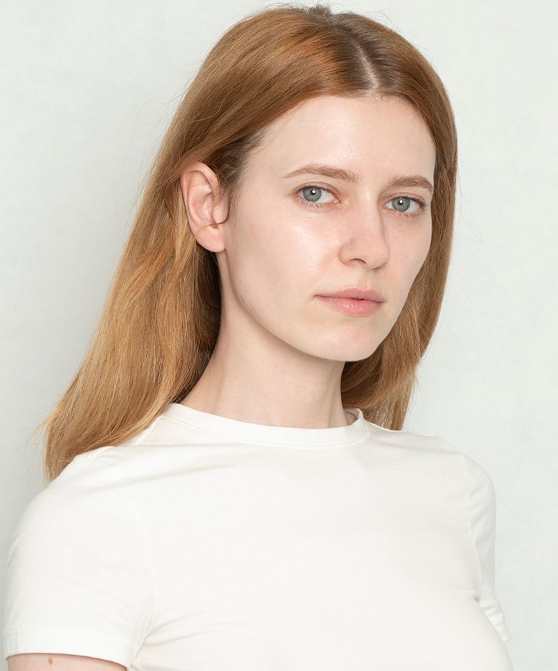 Nancy, English teacher at Piece of Cake — warm smile, red hair, white top